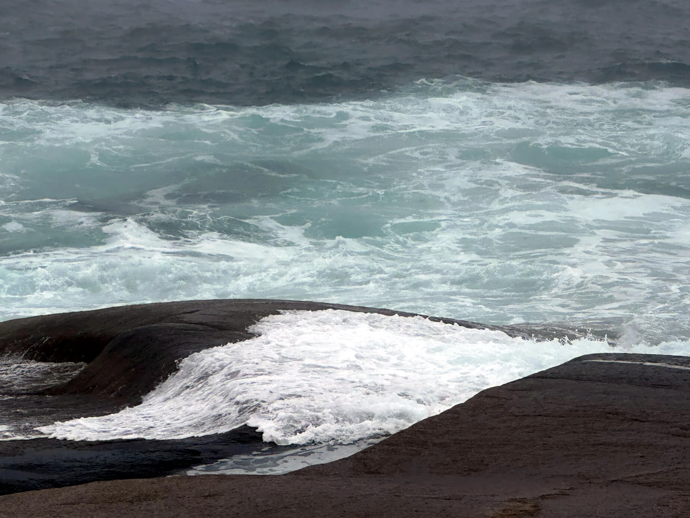 Atlantic waves breaking onto a dark Nova Scotia beach